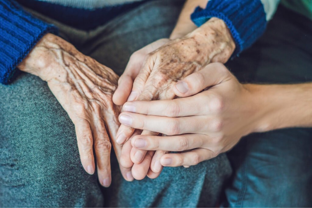 Young woman's hands holding old woman's hands. Atwell Care Ltd. Live in care. Home Care. Care Company. Bath. Frome. Keynsham. Saltford.